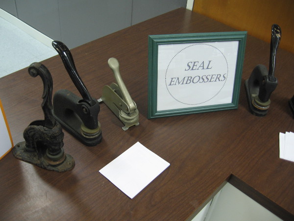 A collection of old City Clerk seal embossers.
