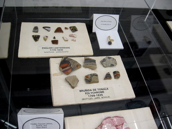The exhibit includes fragments of bottles, jars, bowls and plates from early San Diego.