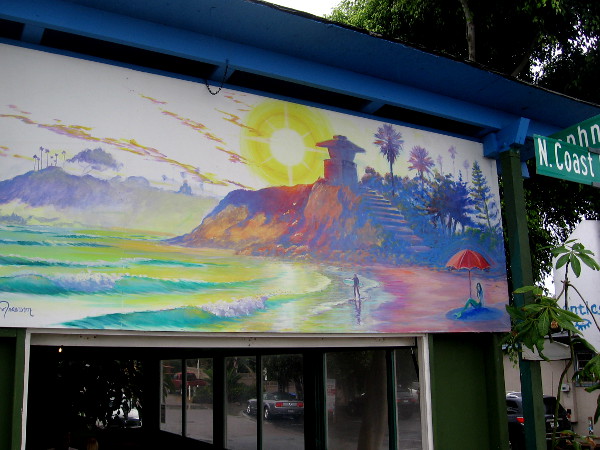 Another cool mural above a window with a colorful beach scene.