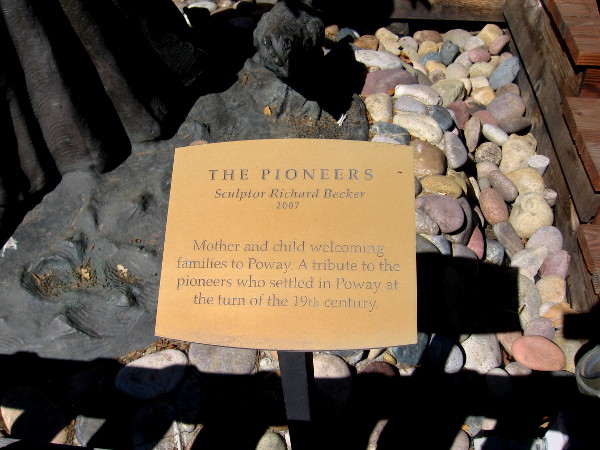 Plaque reads: The Pioneers. Sculptor Richard Becker, 2007. Mother and child welcoming families to Poway. A tribute to the pioneers who settled in Poway at the turn of the 19th century.