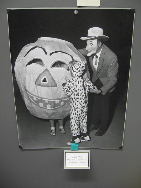 Man and Children in Halloween costumes, circa 1960.