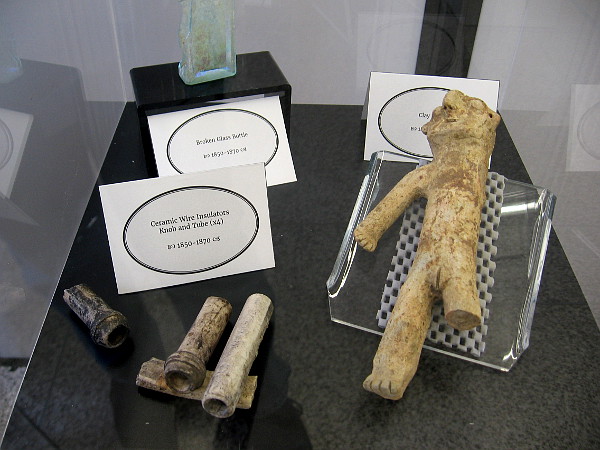 Other early artifacts from New Town include a broken bottle, ceramic wire insulators and a clay effigy.