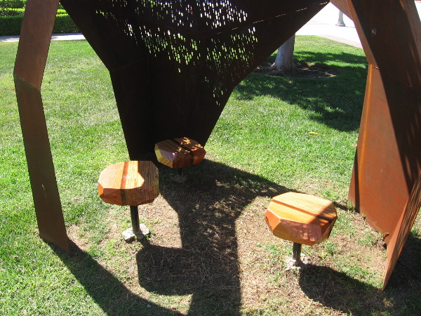 Three can sit near each other in this shady sculpture and share an experience.