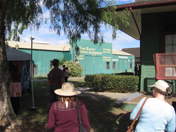 People in Grape Day Park head toward buildings that are part of the Escondido History Center's Heritage Walk.