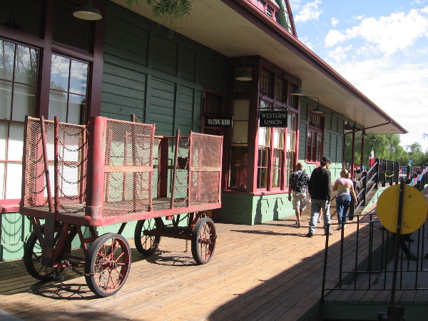 The platform side of the historic train depot, complete with Western Union sign and vintage luggage cart.
