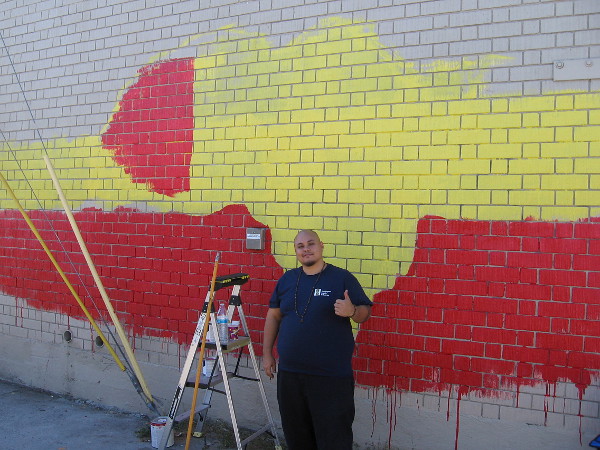 GMONIK @gmonikart has begun a new mural in the alley by 7-Eleven. It will depict Africa and the message One Love.