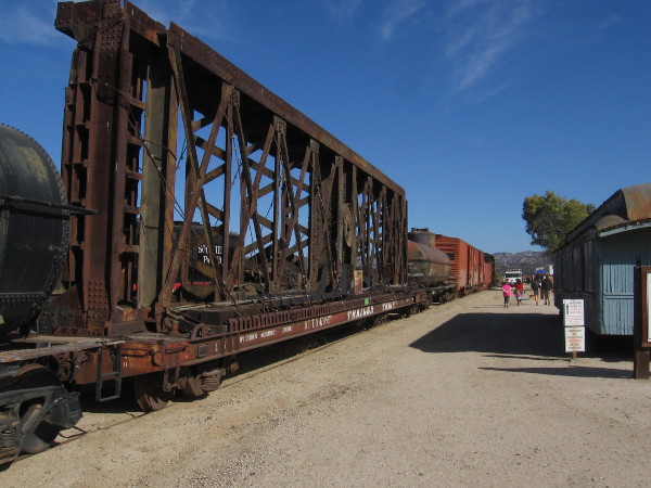 On top of one flatcar is a huge turntable that was used for turning railroad locomotives and cars.