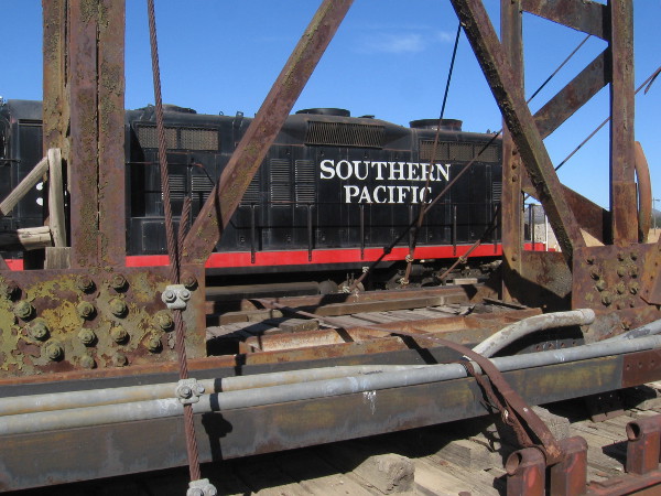 A cool photo of a nearby Southern Pacific locomotive through the transported turntable.