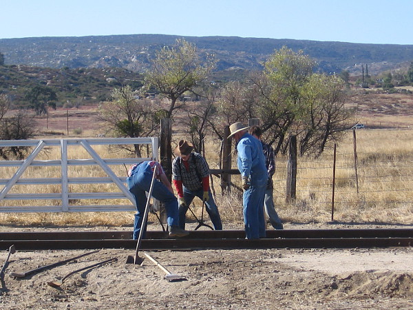 Reenactment of workers completing a transcontinental railroad route.