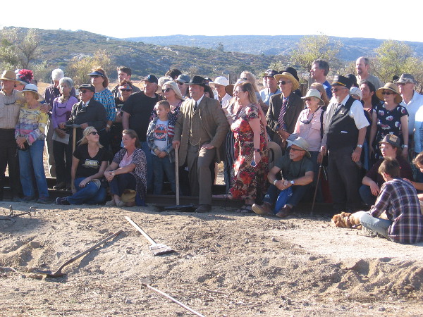 Those attending the big centennial celebration assemble around the John D. Spreckels reenactor for a photograph.