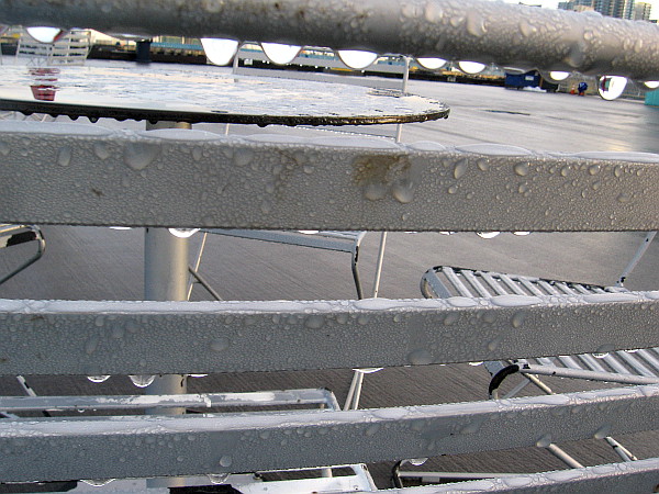 Dew drops on the outdoor chairs and tables.