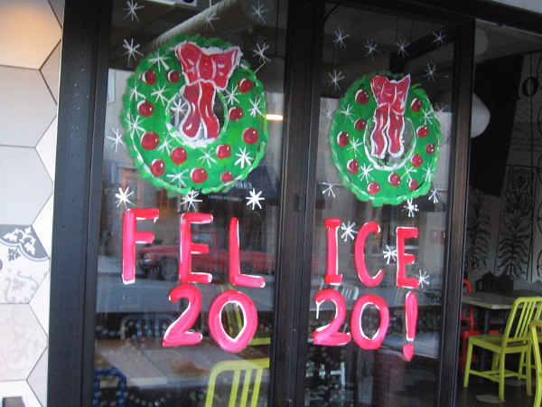 Felice 2020! painted on a restaurant window.