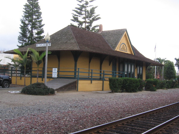 Train tracks pass the Santa Fe Depot. The modern Carlsbad Village Station is located one block to the north.