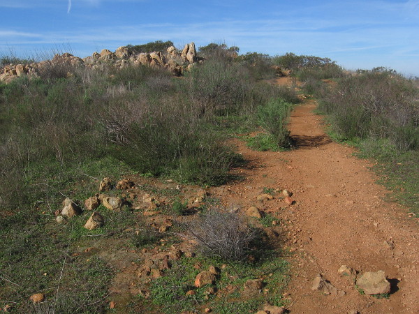 Continuing along, we approach another rocky outcropping atop Mother Miguel Mountain.