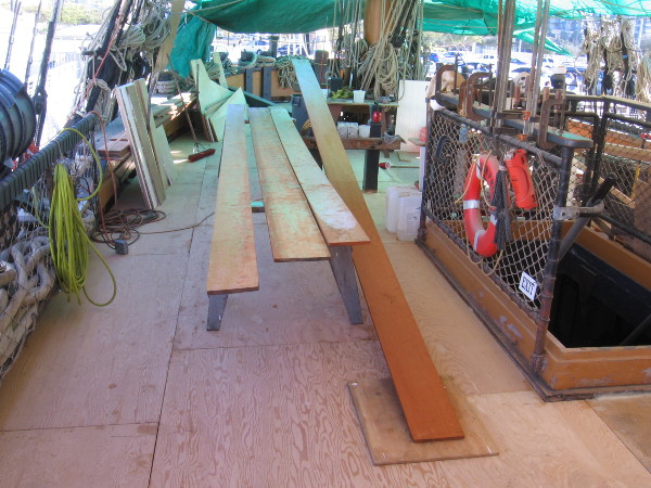 Lumber is prepared on the main deck of HMS Surprise during the famous tall ship's re-decking project.