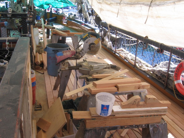 The main deck of HMS Surprise is full of lumber, saws and other woodworking tools!