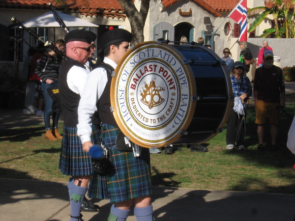 The big, booming House of Scotland Pipe Band drum keeps rhythm with the assembled bagpipers.