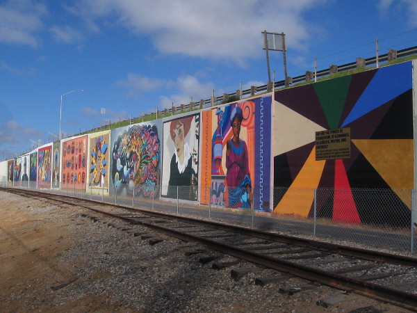 A row of bold murals that represent different art styles through history.