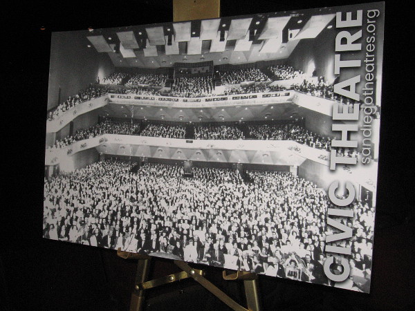 Old black and white photograph shows a packed house.