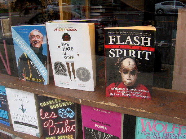 Human thought and endeavor endure in a bookstore window.