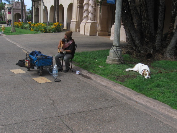 A street performer and his dog on Balboa Park's normally busy El Prado.