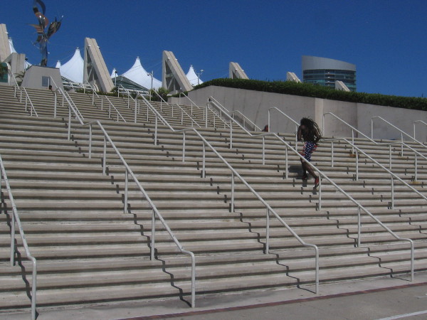 An athlete trains by running up and down the steps of the San Diego Convention Center.