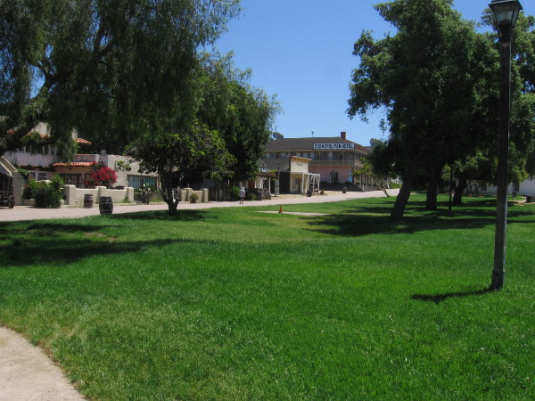 The plaza in the middle of Old Town San Diego State Historic Park is deserted. But the grass is long and green!
