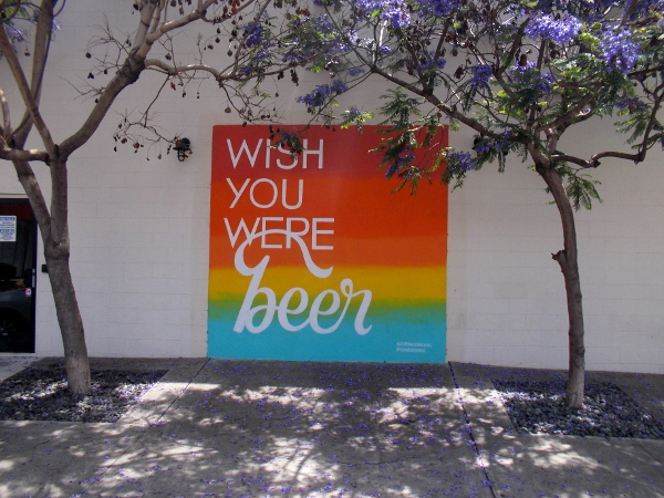 Graphic on wall of Coronado Brewing Company San Diego Tasting Room. WISH YOU WERE beer.