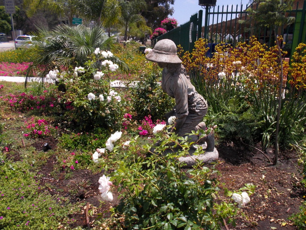 Sculpture of lady tending her garden in front of the Armstrong Garden Center.