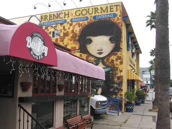 A large face greets those heading east on Turquoise Street in Pacific Beach.