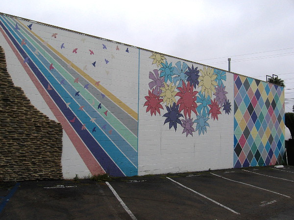 Mural on parking lot wall by Treelogy Cafe Restaurant.