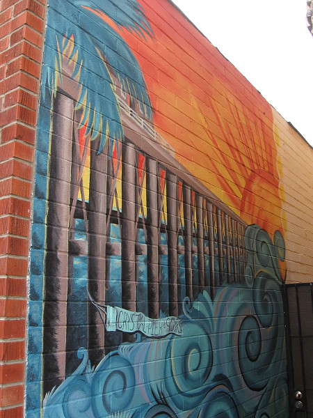 Mural in a narrow alley celebrates 90 years of Crystal Pier.