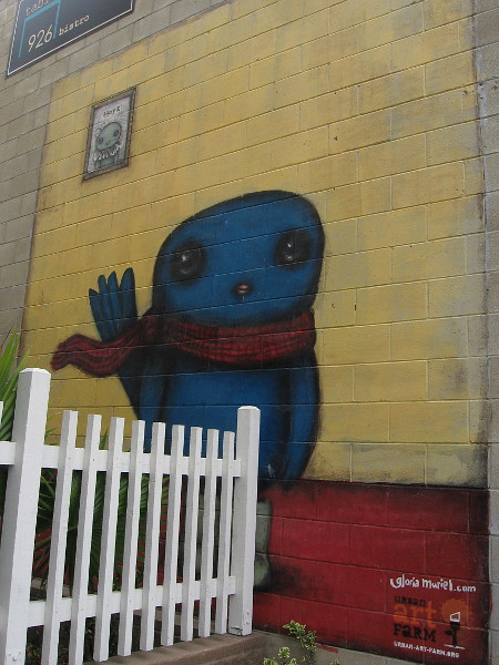 A fun blue character painted on another nearby wall by Gloria Muriel.
