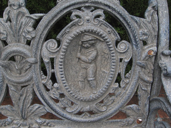 One scene on the metal bench seems to depict a villager working in a field.