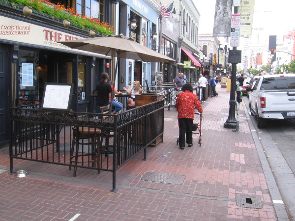 A few customers sit in front of The Field Irish Pub.