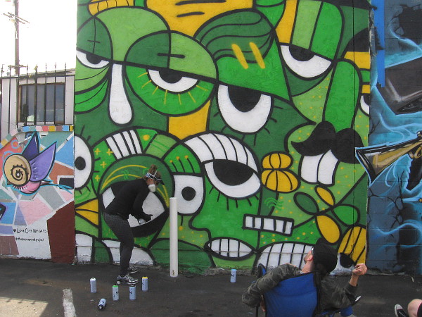 Sandra Escobar paints a cool mural on the side of Super Cocina in City Heights.