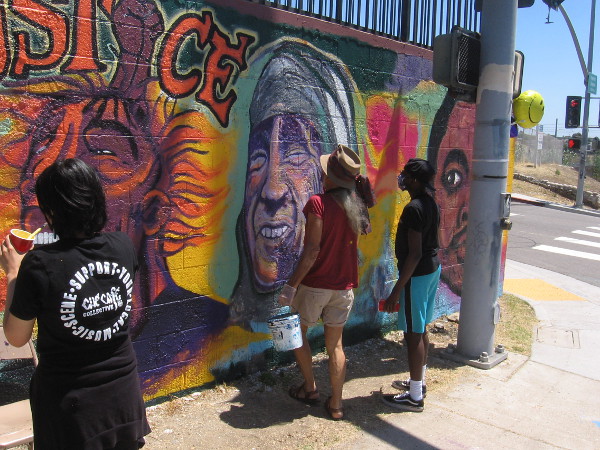 A team of local artists works to restore the Civil Rights mural at 32nd Street and Imperial Avenue in San Diego.