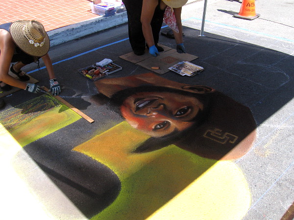 Cecelia Linayao produces Padres baseball chalk art in the Gaslamp Quarter during the first weekend of the 2020 season.