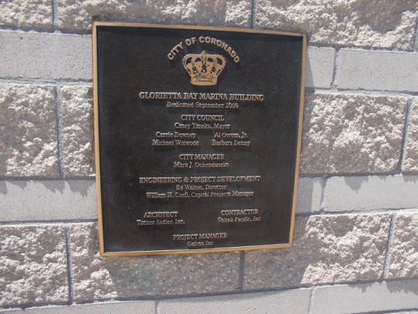 Plaque near stairs to outdoor second level of the Glorietta Bay Marina Building.