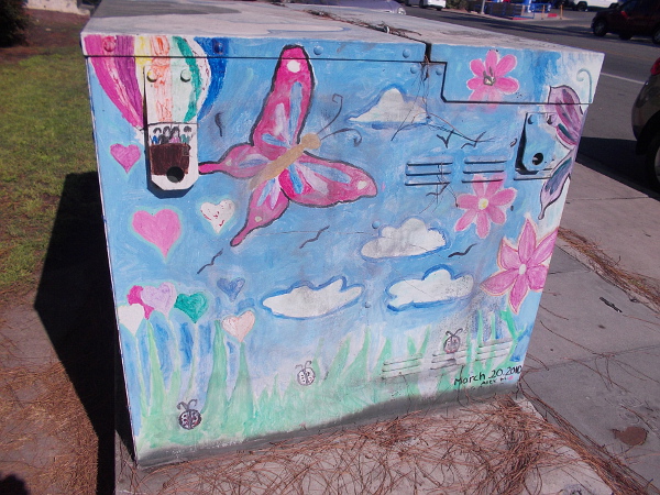 Butterfly rises near a hot air balloon.