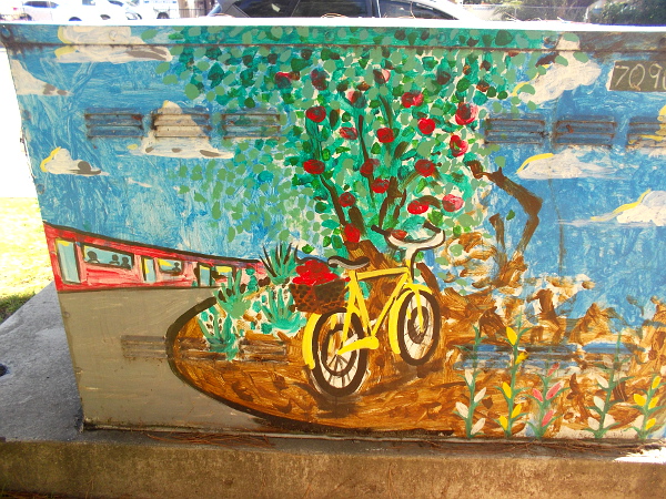 Bicycle by a fruit tree, and a trolley in the background.