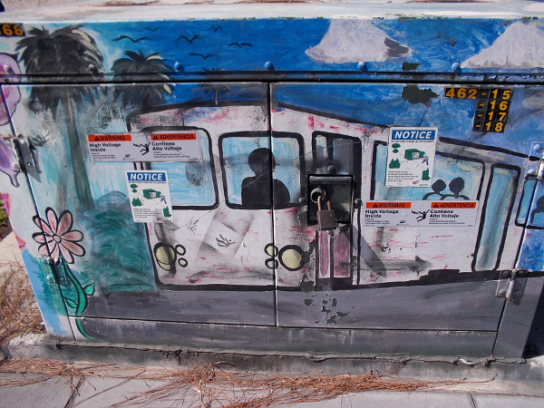 Trolley driver emerges from a painted electrical box.