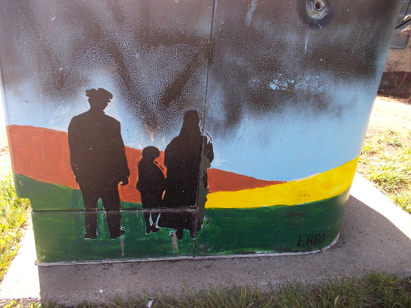 A family on a sweeping, colorful landscape.