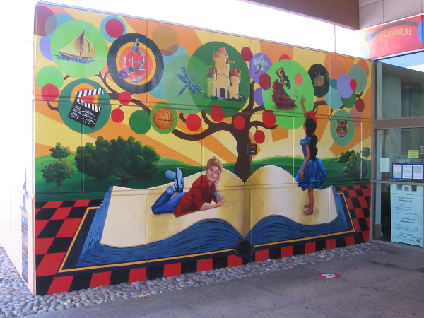 A fantastic mural near front door of the library. Kids activate their imagination and ambitions with a book.