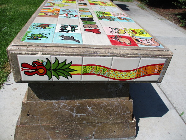 Quetzalcoatl on the side of one bench.