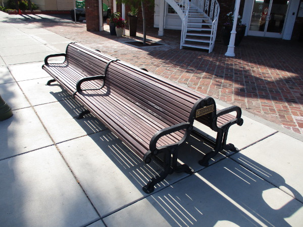 A bench at the south end of Maple Street Plaza on Grand Avenue.