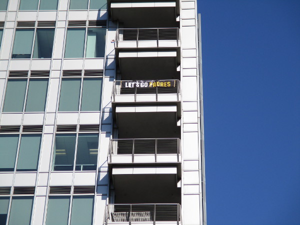 Banner on high balcony overlooking Petco Park's outfield proclaims: Let's Go Padres.
