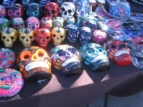 A vendor was selling lots of colorfully decorated Día de los Muertos skulls.