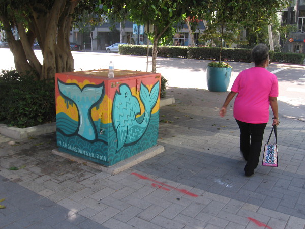 Someone walks past this fun street art by Nicholas Danger, another cool local artist!