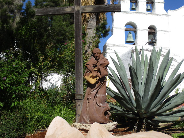 Sculpture of Fray Junípero Serra in front of the Mission San Diego de Alcalá facade.